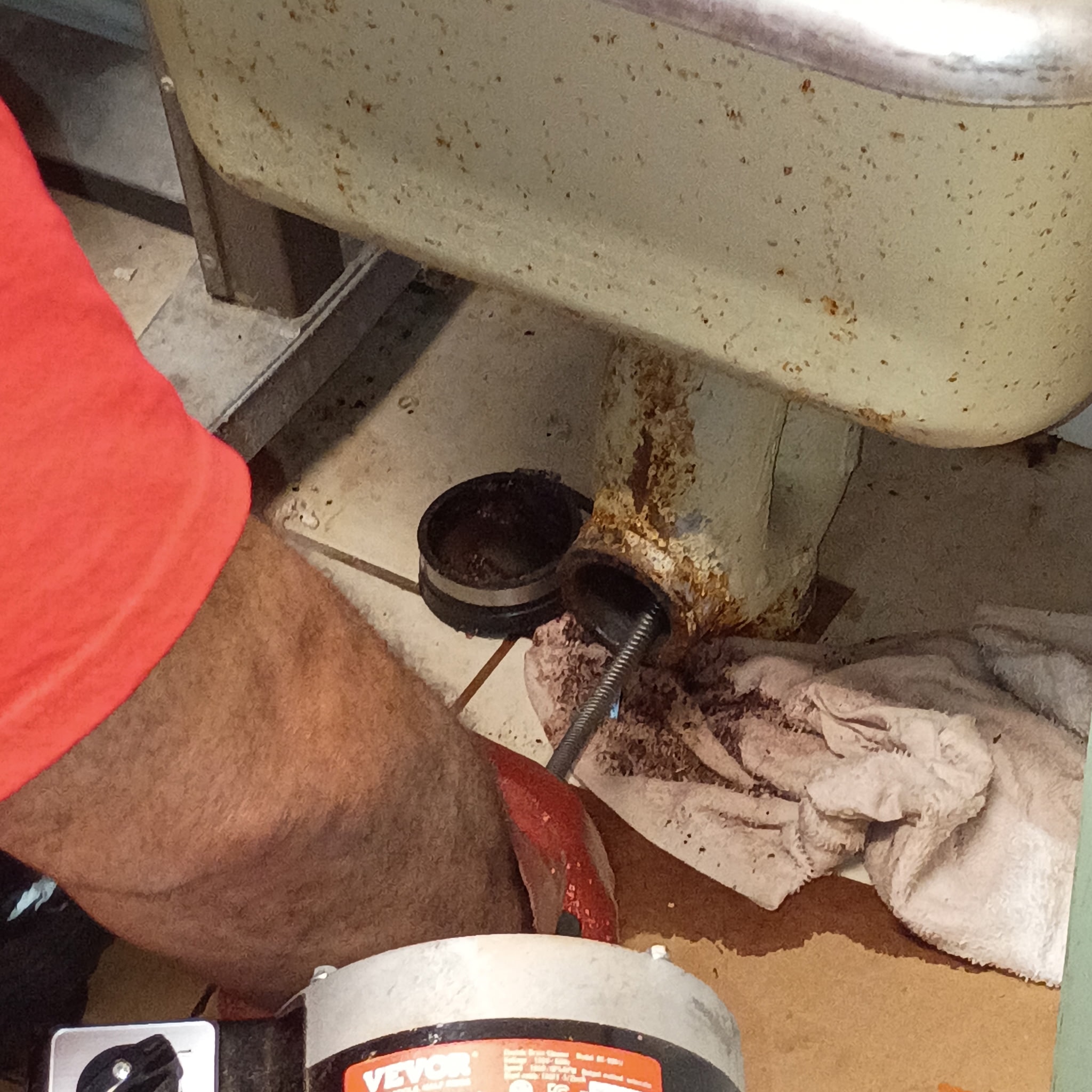 Plumbing repair beneath a bathroom sink