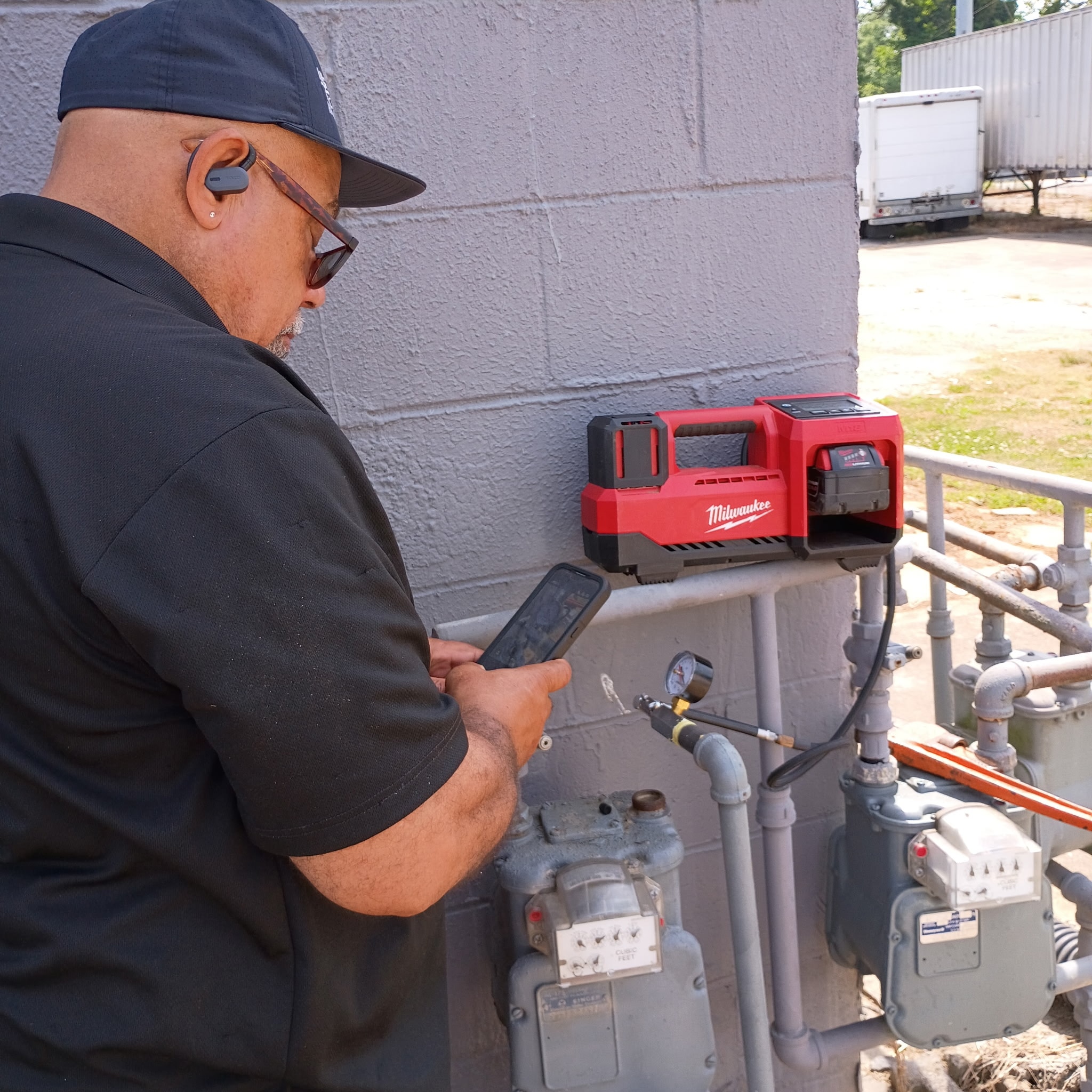 Technician inspecting gas meter equipment